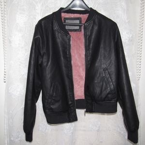 Black leather jacket with pink fur inside.